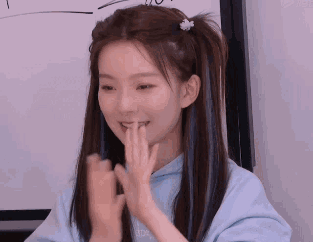 a girl wearing a blue sweatshirt with the word tdp on it