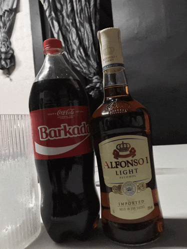 a bottle of alfonso i light next to a bottle of barkada
