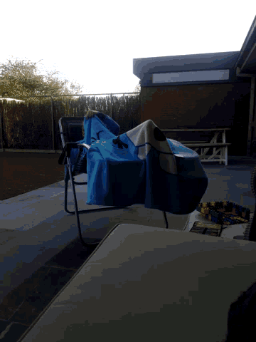 a blue towel with a butterfly on it sits on a chair