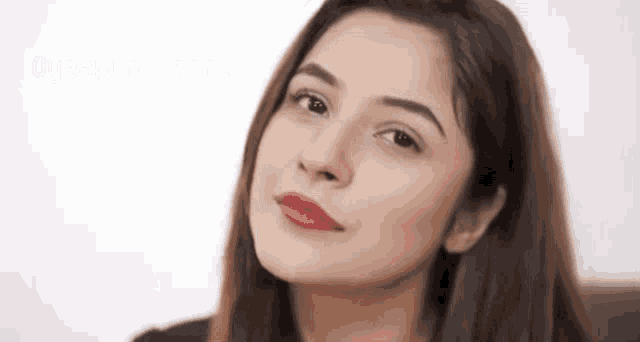 a close up of a woman 's face with red lipstick looking up .