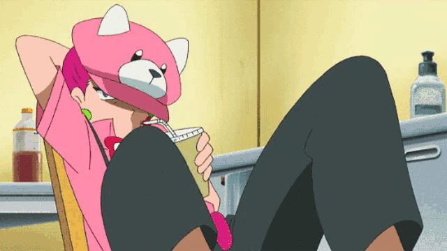 a girl wearing a pink teddy bear hat is laying on the floor