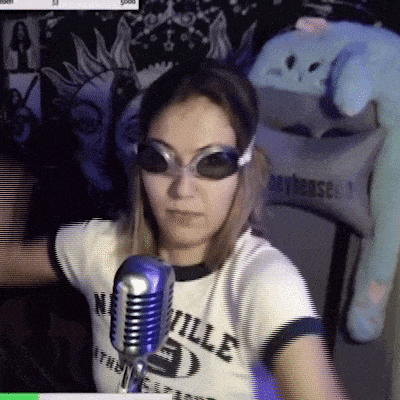 a woman wearing sunglasses stands in front of a microphone that says " nashville " on it