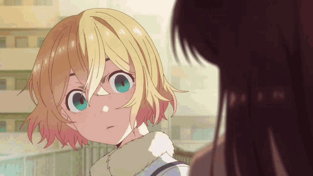 a girl with yellow hair and blue eyes is looking at another girl
