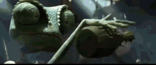 a close up of a chameleon holding a frog