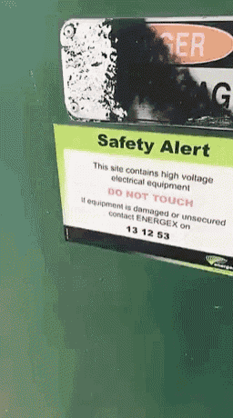 a sign on a green wall that says safety alert