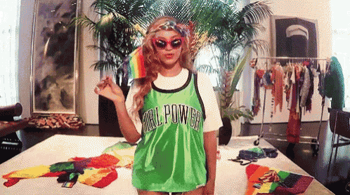 a woman wearing a green girl power jersey