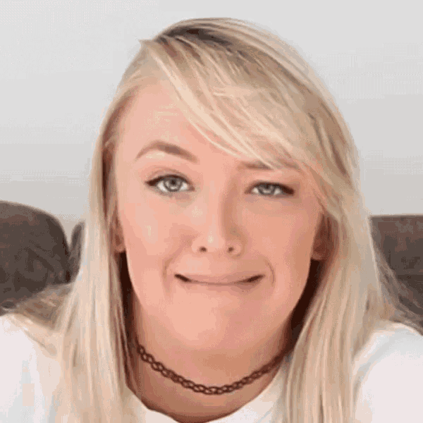 a woman with blonde hair and blue eyes is wearing a choker necklace .