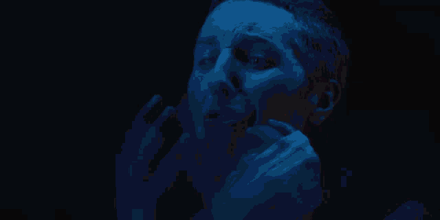 a close up of a woman screaming with her mouth wide open