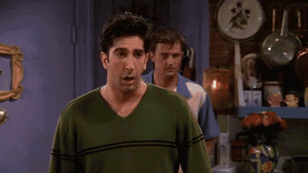 a man in a green shirt is screaming and says `` fine by me '' while standing in front of two other men .