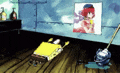 spongebob squarepants is sitting on a wooden floor next to a picture of a girl .