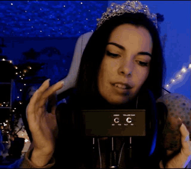 a woman wearing a tiara and headphones has the letters cc on her headphones