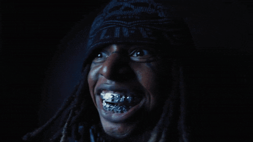 a close up of a person 's face with dreadlocks and braces