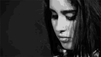 a black and white photo of a woman 's face