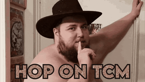 a shirtless man in a cowboy hat holds his finger to his lips and the words hop on tcm are visible