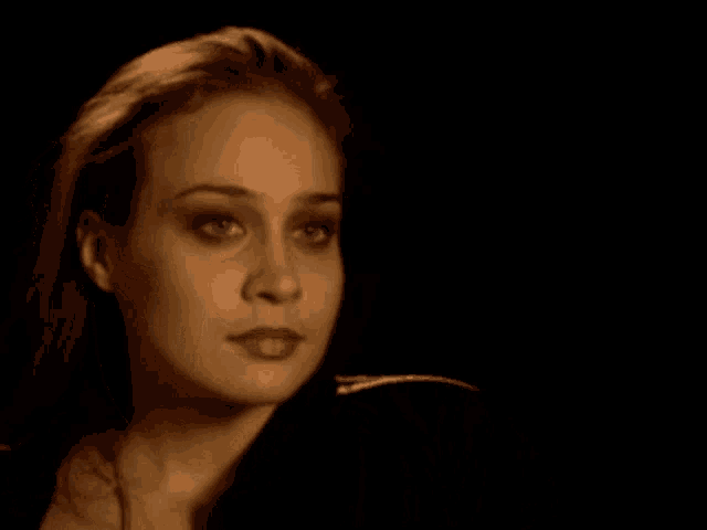 a close up of a woman 's face with dark eyes