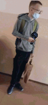 a man wearing a mask is holding a microphone in his hand .