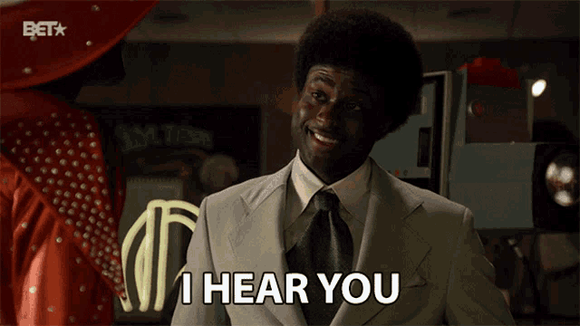 a man in a suit says " i hear you "