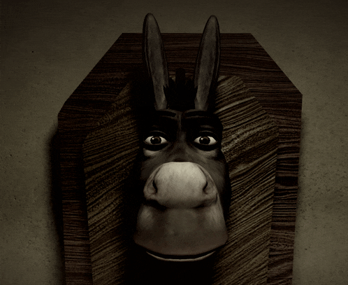 a donkey 's head is displayed on a wooden plaque