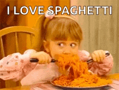 a little girl is eating a plate of spaghetti with a fork and knife .