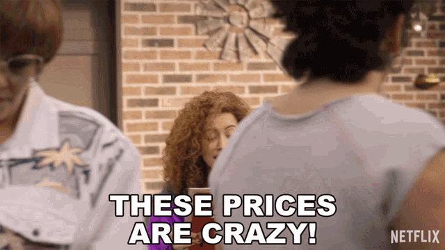 a woman says these prices are crazy in front of two other women