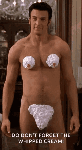 a naked man with whipped cream on his chest and breasts