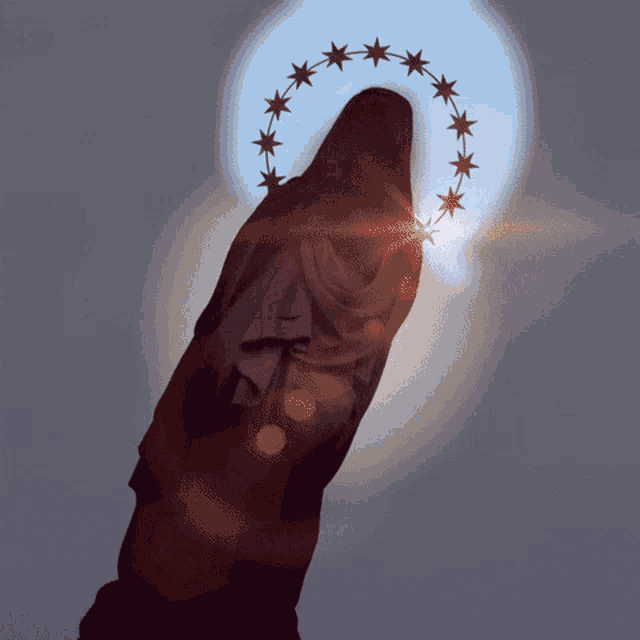 a statue with a halo of stars surrounding it