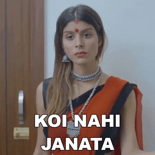 a woman in a red and black saree is standing in front of a door with the words koi nahi janata below her