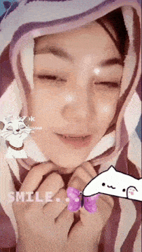 a woman wearing a purple and white striped blanket has a cartoon cat on her face and the words smile on the bottom left