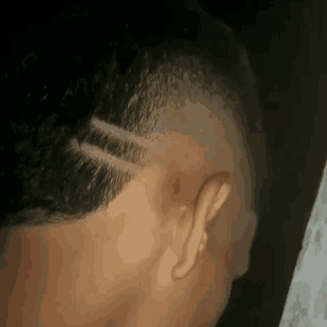 a close up of a man 's head with a shaved design in it .