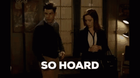a man and a woman are standing next to each other in a living room .