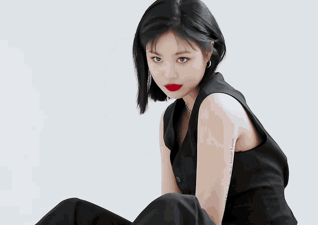 a woman with red lipstick and a tattoo on her arm