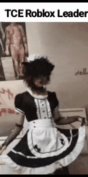 a man in a maid costume is sitting on a couch .