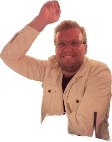 a man wearing glasses and a white jacket is smiling and raising his fist in the air
