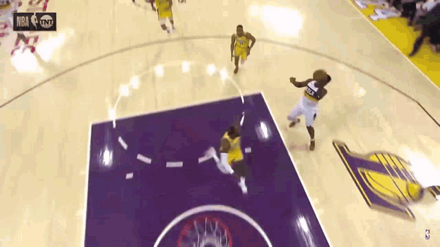 a basketball game is being played on a purple court