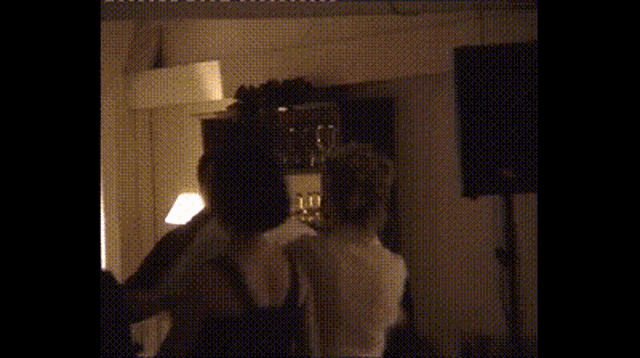 a woman 's head is visible in a dark room with a window