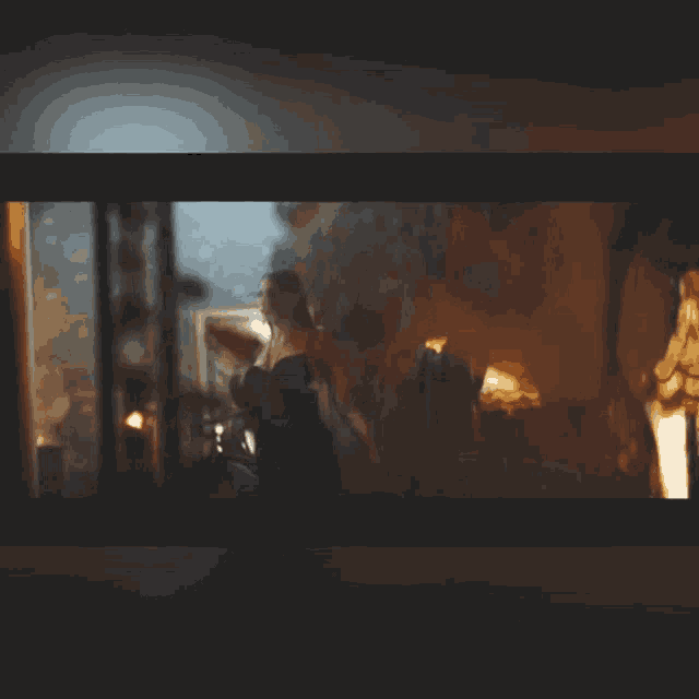 a blurry picture of a woman standing in a room