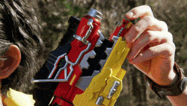 a person is holding a toy gun with a card that says tyrica on it