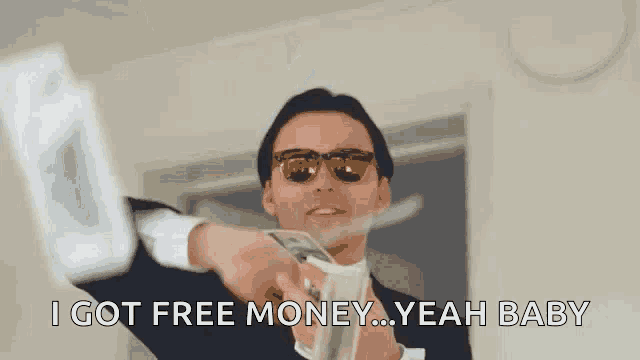 a man in a suit and tie is throwing money in the air and holding a stack of money .