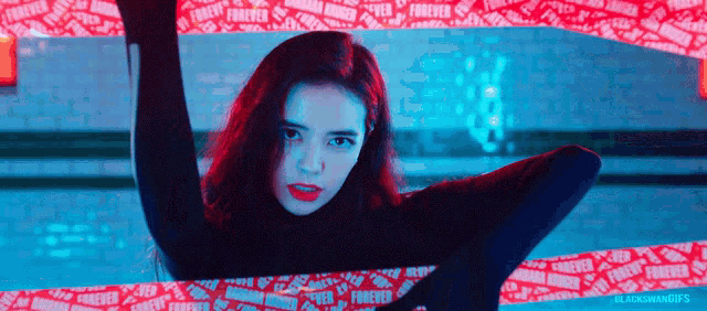 a woman is standing in front of a red and blue background with the word forever written on it