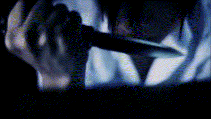 a blurry image of a person holding a knife in their hand