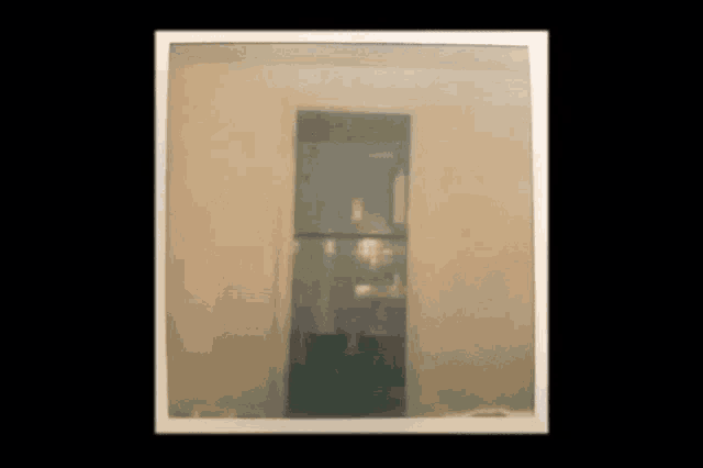 a picture of a door in a room with a white frame