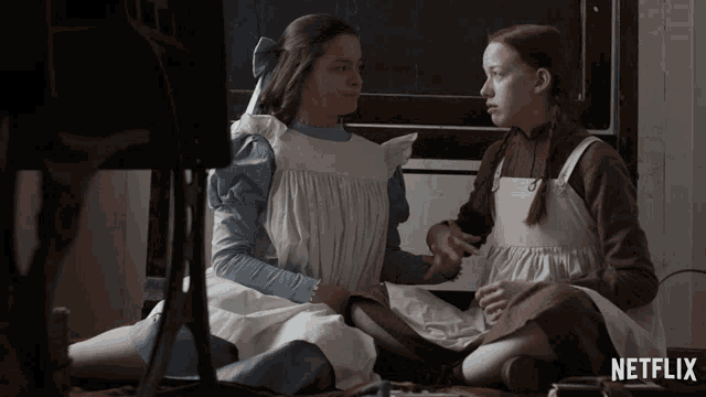 two girls sitting next to each other with netflix written on the bottom