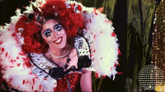 a woman dressed as queen of hearts is smiling