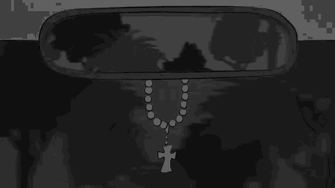 a rear view mirror with a rosary hanging from it .