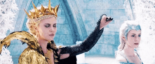 a woman with a crown on her head is standing next to another woman .
