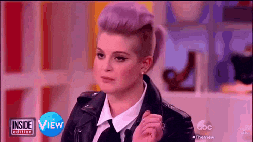 a woman with purple hair and a leather jacket is on the inside edition of the view