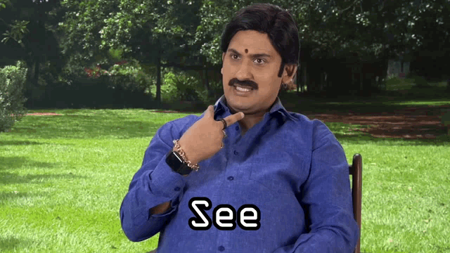 a man in a blue shirt with the word see written on his shirt