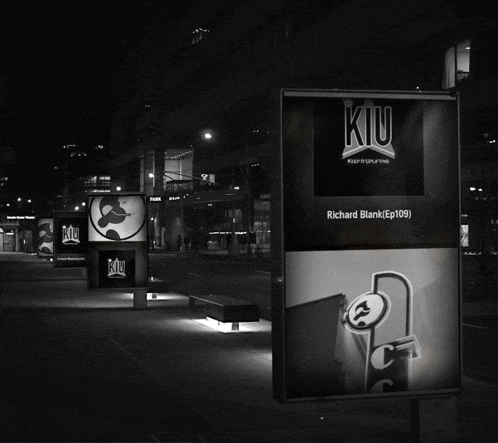 a black and white photo of a row of kiu ads