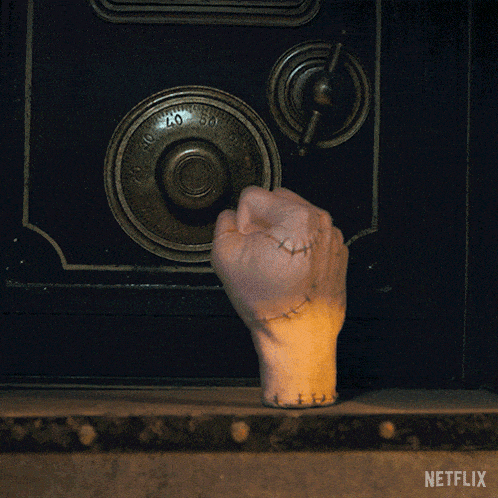 a hand with stitches on it is reaching into a safe with a netflix logo on the bottom