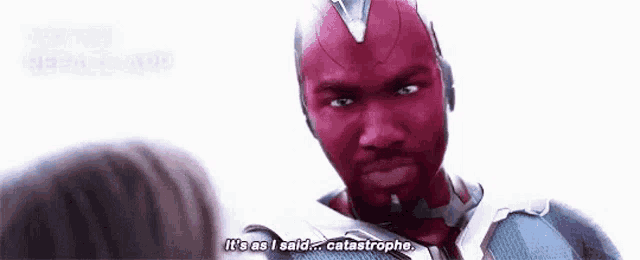 a man in a red suit is talking to a woman and says `` it 's as i said ... catastrophe . ''